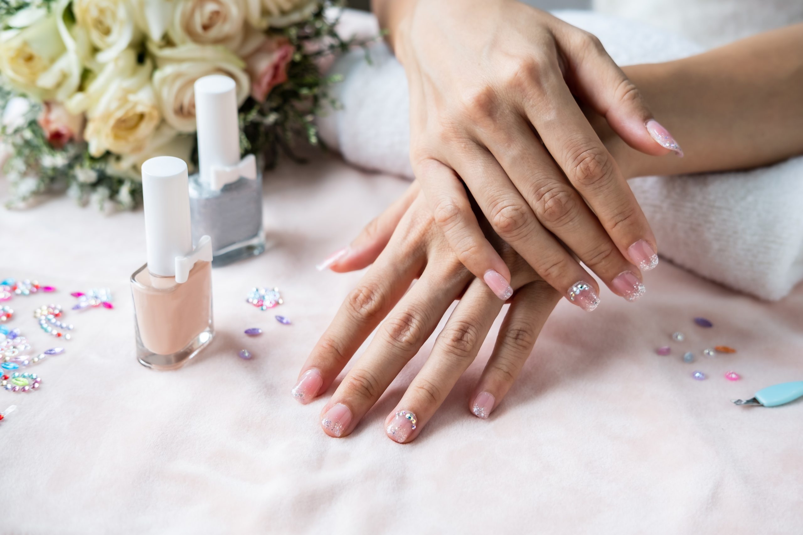 Glossy manicure with glitter and gem accents at GENESIS NAIL SPA in Marietta, GA
